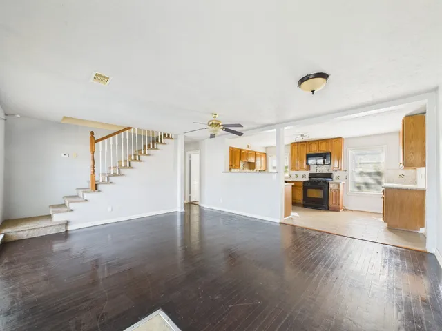 a view of a living room and kitchen with a sink cabinet and a living room