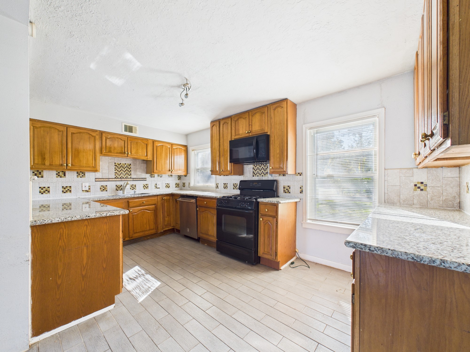 3814 Luca Street Houston, TX 77021 - Photo 6 of 31 a large kitchen with a sink and cabinets