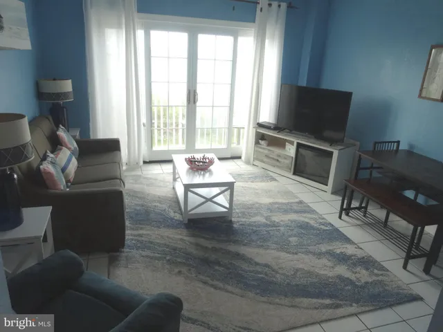 a view of a livingroom with furniture and a flat screen tv