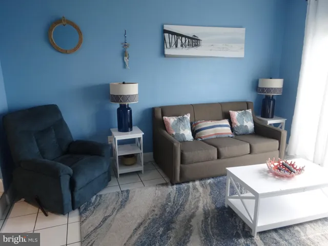 a view of a livingroom with furniture and a floor to ceiling window
