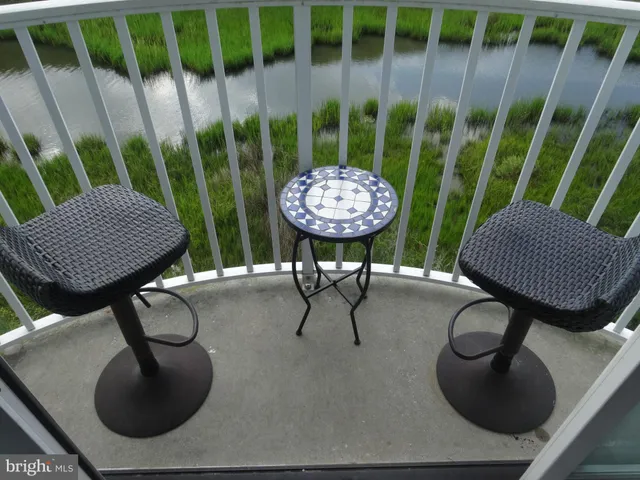 a kitchen with stainless steel appliances kitchen island granite countertop a refrigerator and a stove