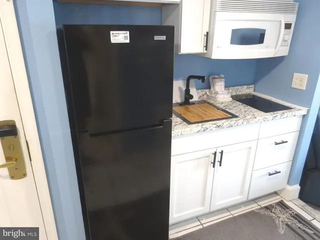 a bathroom with a sink vanity and a mirror