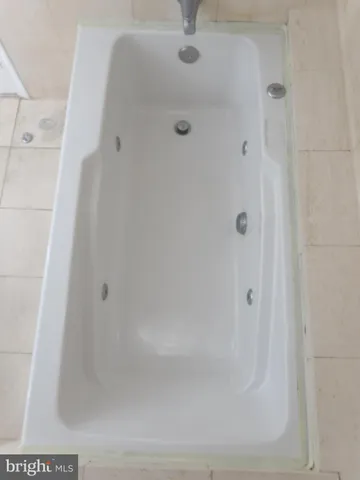 a bedroom with a bed and a lamp