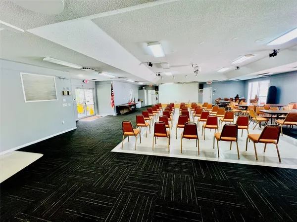 a living room with lots of furniture and kitchen view