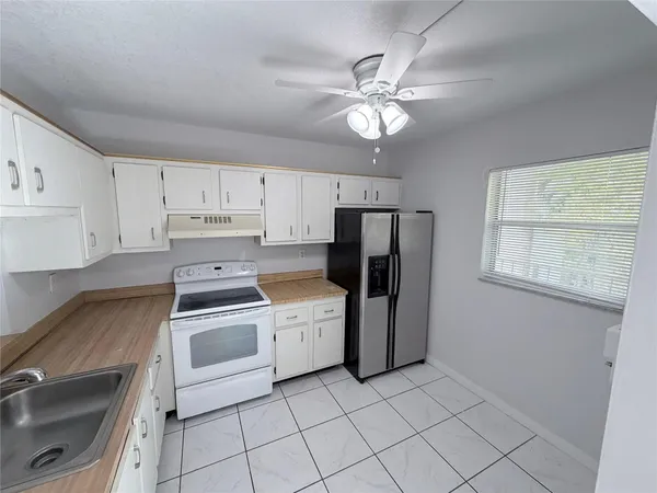 a kitchen with stainless steel appliances a stove a sink and a refrigerator
