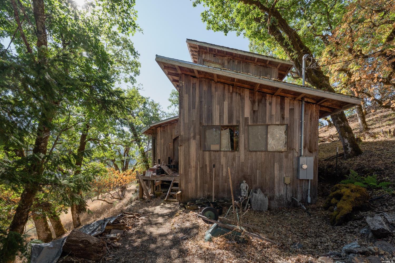 5275 First Gate Road Willits, CA 95490 - Photo 1 of 1 a wooden fence with trees in the background