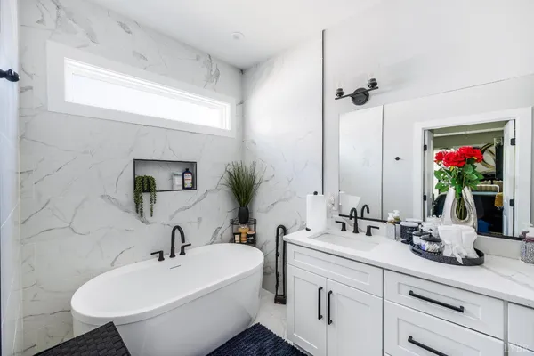 a white toilet sitting next to a bathroom sink