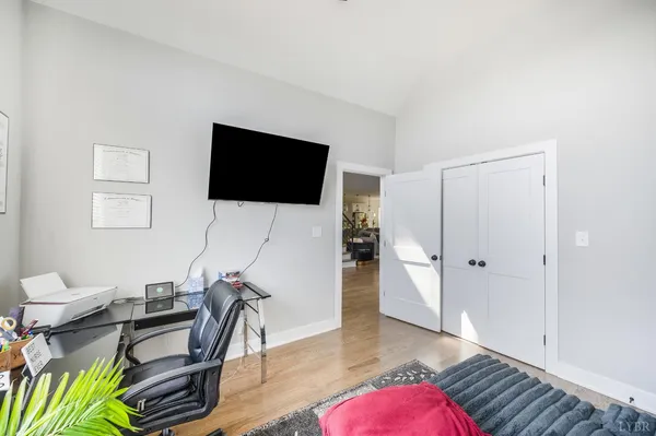 a bedroom with a bed closet and a large window
