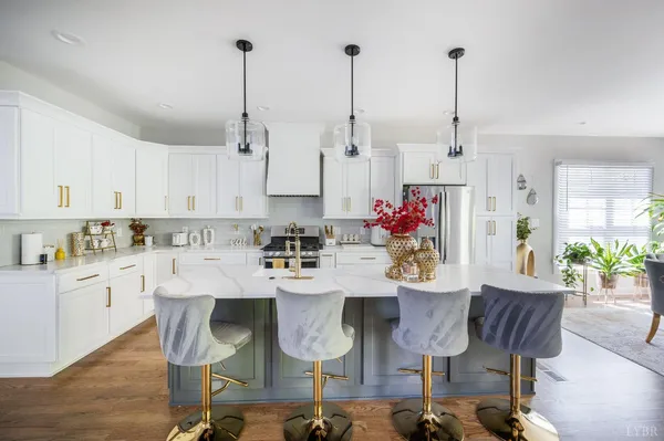 a view of kitchen with stainless steel appliances granite countertop furniture dining table and chairs