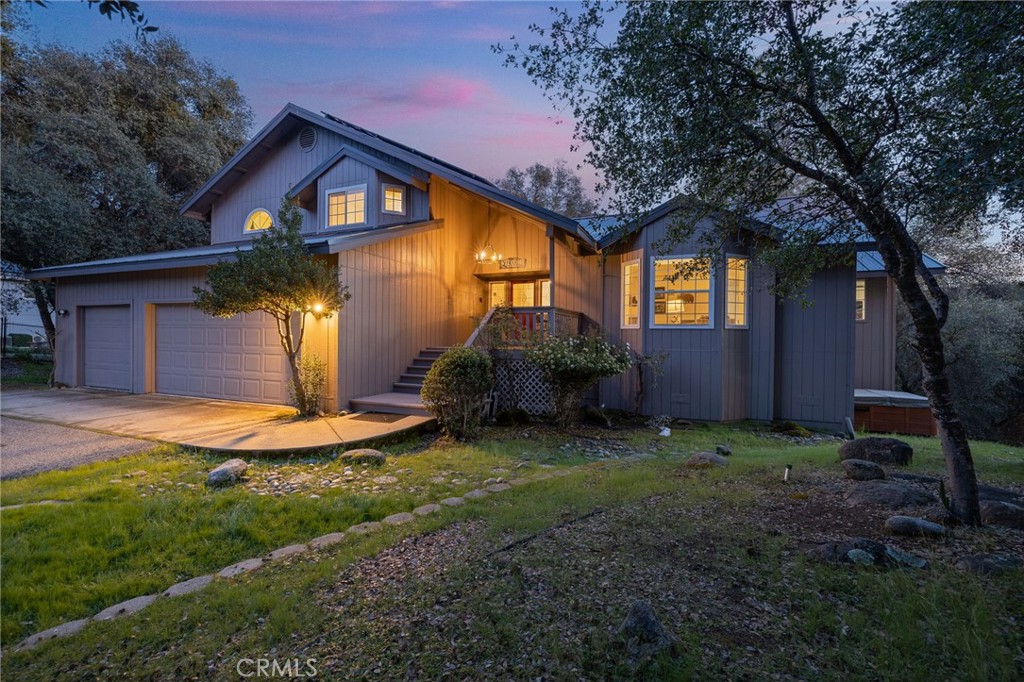 39301 Moonray Lane Oakhurst, CA 93644 - Photo 1 of 55 a front view of a house with garden