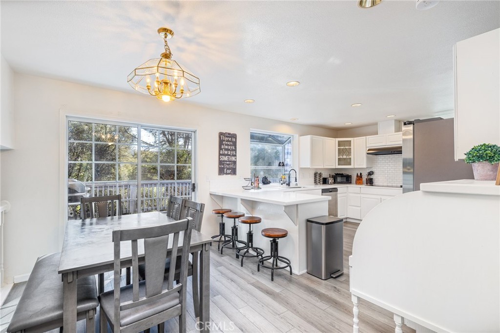 39301 Moonray Lane Oakhurst, CA 93644 - Photo 12 of 55 a kitchen with stainless steel appliances a dining table and chairs
