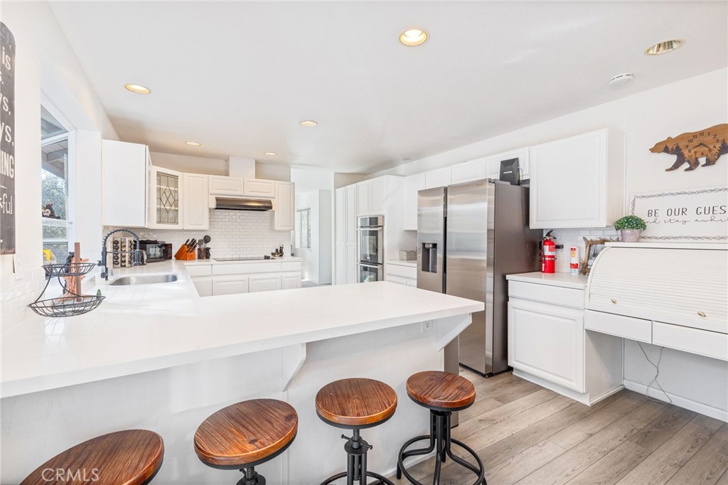 39301 Moonray Lane Oakhurst, CA 93644 - Photo 13 of 55 a kitchen with kitchen island a stove a table and chairs