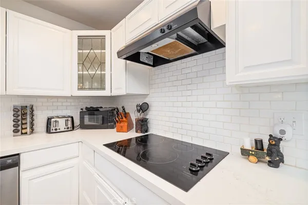 a kitchen with a sink cabinets and a stove top oven
