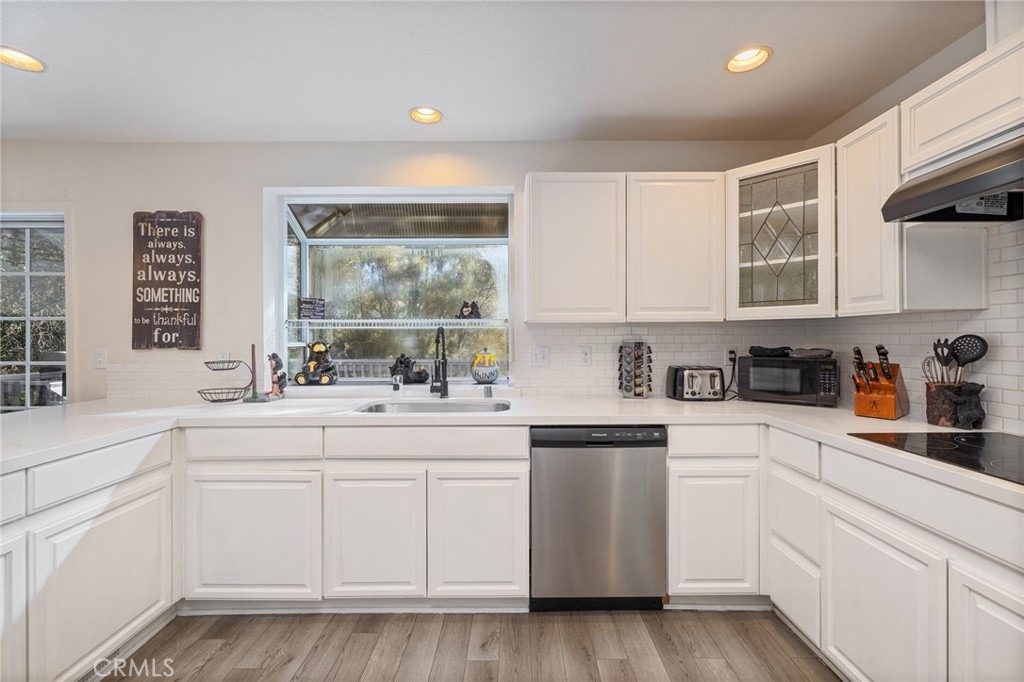 39301 Moonray Lane Oakhurst, CA 93644 - Photo 15 of 55 a kitchen with white cabinets and white appliances