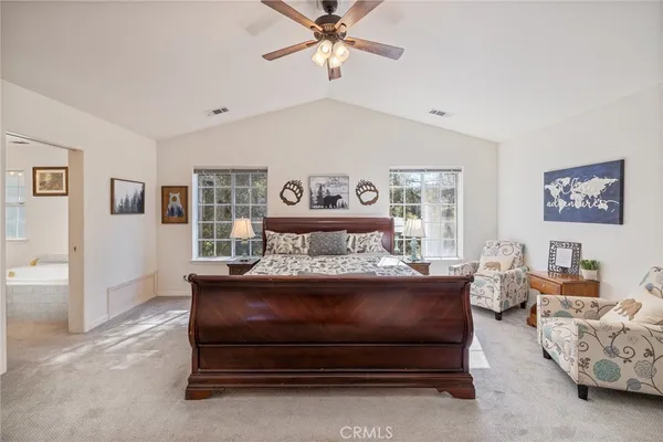 a bed room with furniture and a chandelier