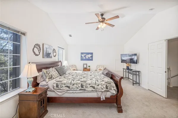 a bedroom with a bed and ceiling fan