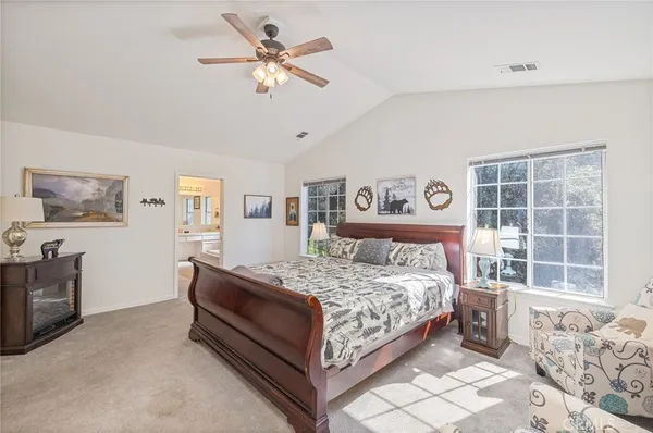 a bedroom with a large bed and a window