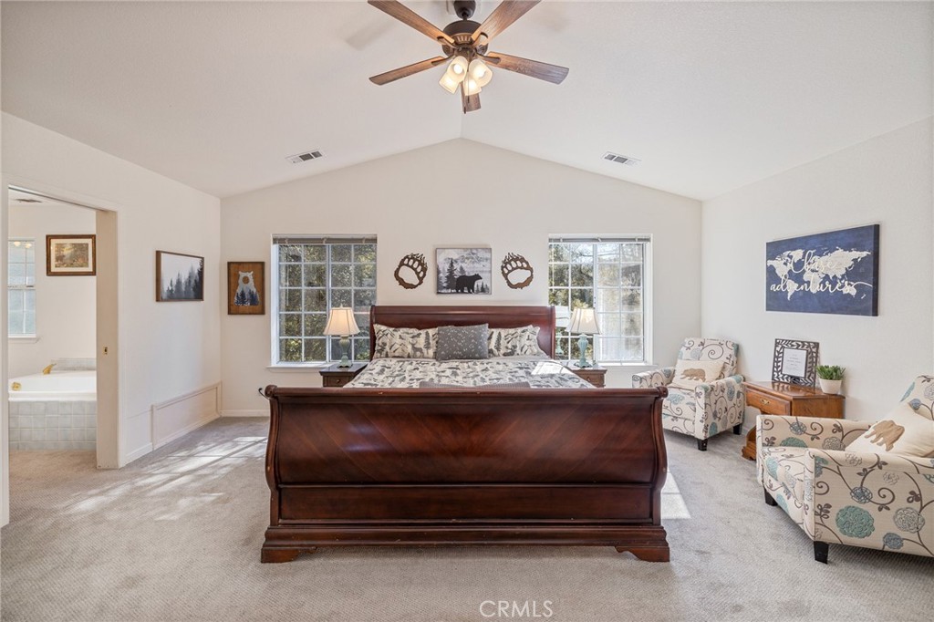 39301 Moonray Lane Oakhurst, CA 93644 - Photo 24 of 55 a bed room with furniture and a chandelier
