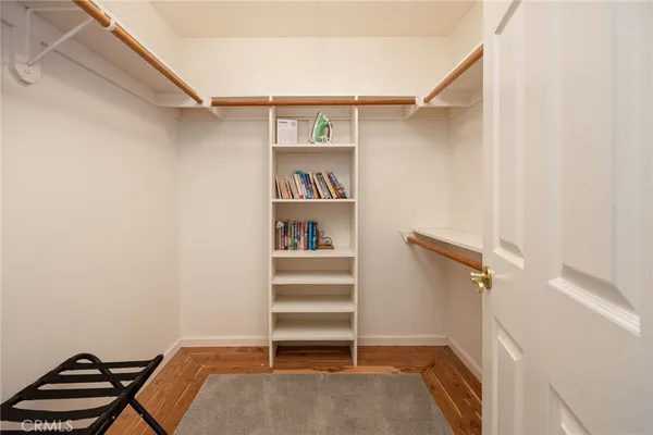 a view of walk in closet with empty racks