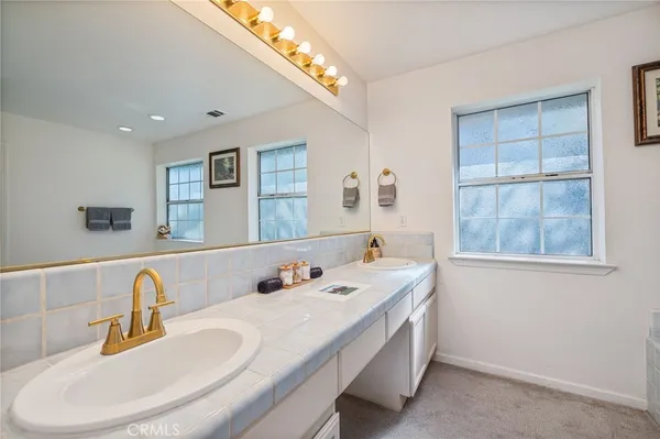 a bathroom with a double vanity sink and a mirror