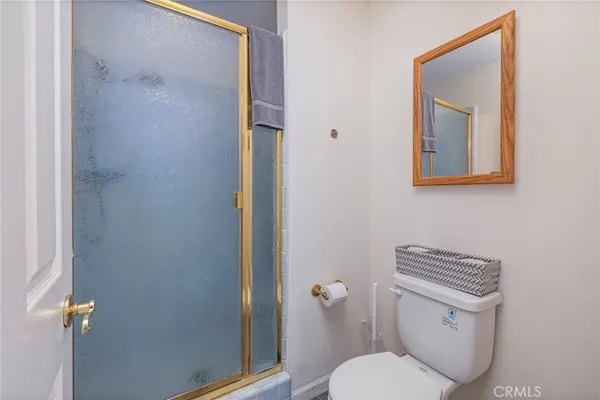 a white toilet sitting next to a bathroom sink