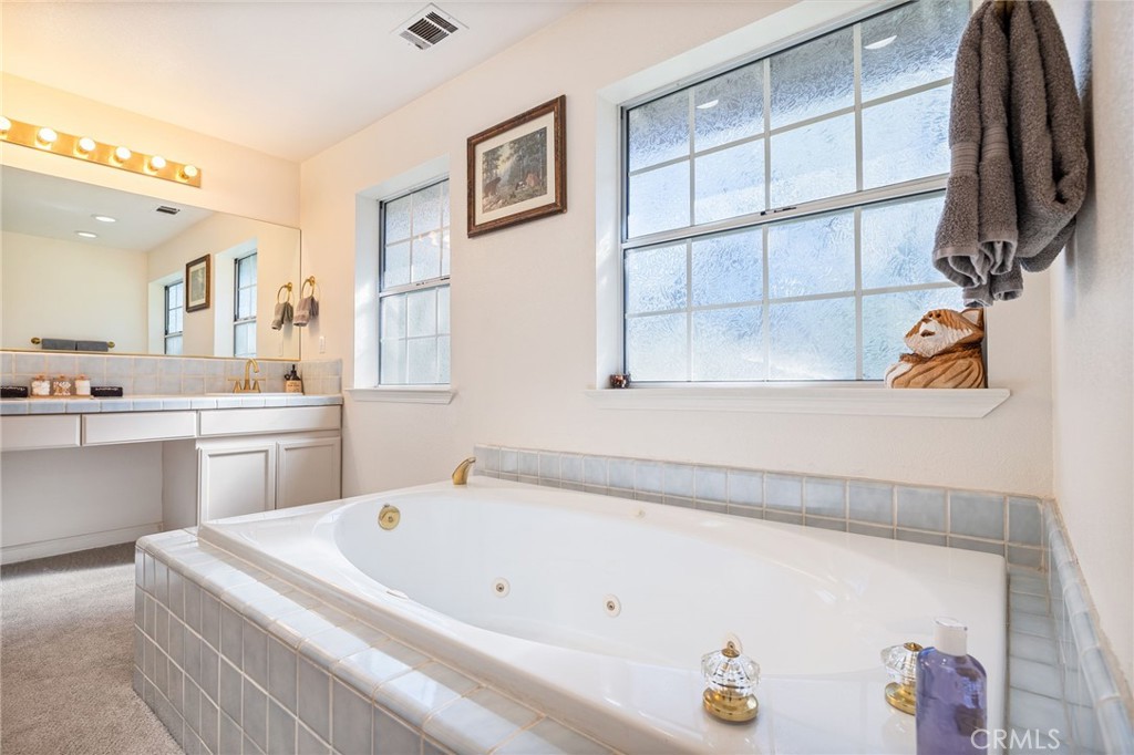 39301 Moonray Lane Oakhurst, CA 93644 - Photo 29 of 55 a bathroom with a tub sink and mirror