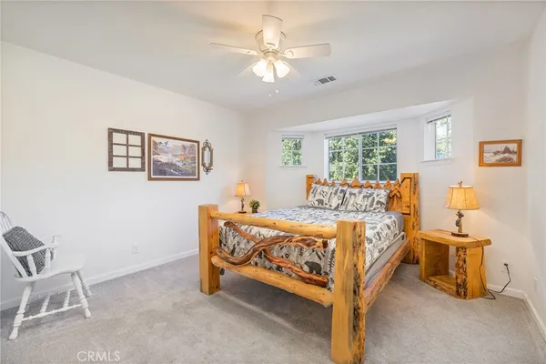 a bed room with a bed and a chair