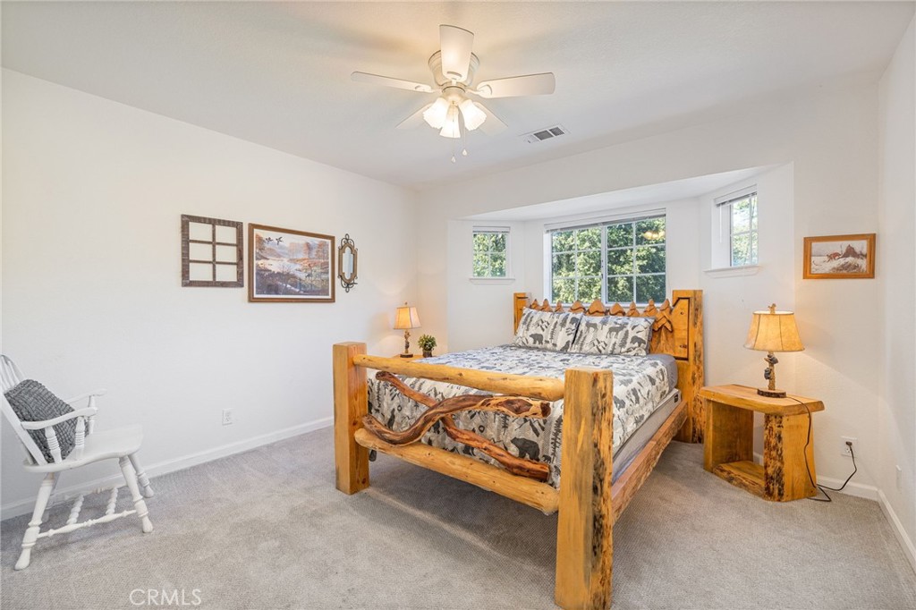 39301 Moonray Lane Oakhurst, CA 93644 - Photo 32 of 55 a bed room with a bed and a chair