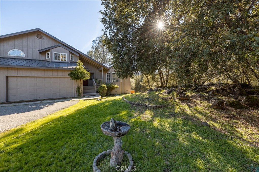 39301 Moonray Lane Oakhurst, CA 93644 - Photo 41 of 55 a front view of a house with garden