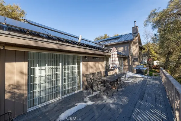 a view of balcony with chairs and wooden fence