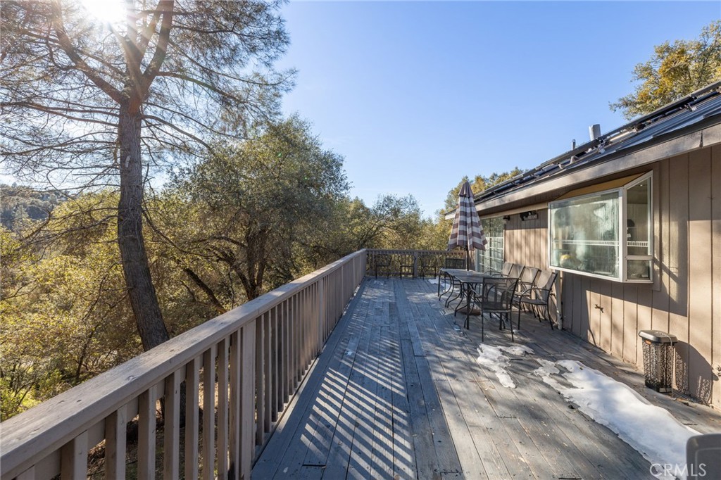 39301 Moonray Lane Oakhurst, CA 93644 - Photo 48 of 55 a view of balcony with chairs and wooden fence