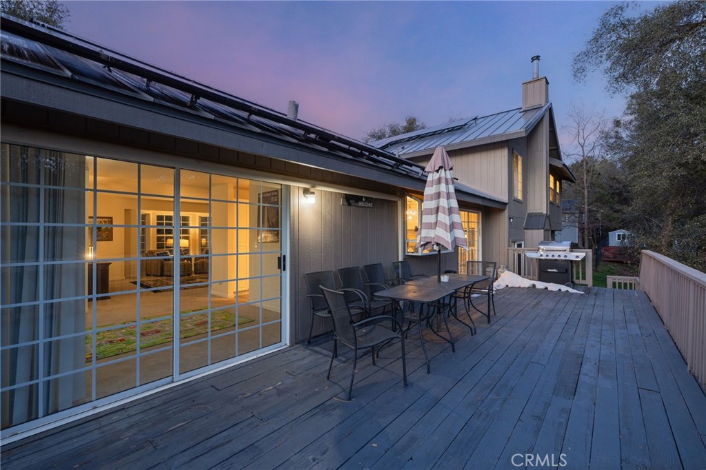 39301 Moonray Lane Oakhurst, CA 93644 - Photo 5 of 55 a view of a deck with table and chairs with wooden floor and fence