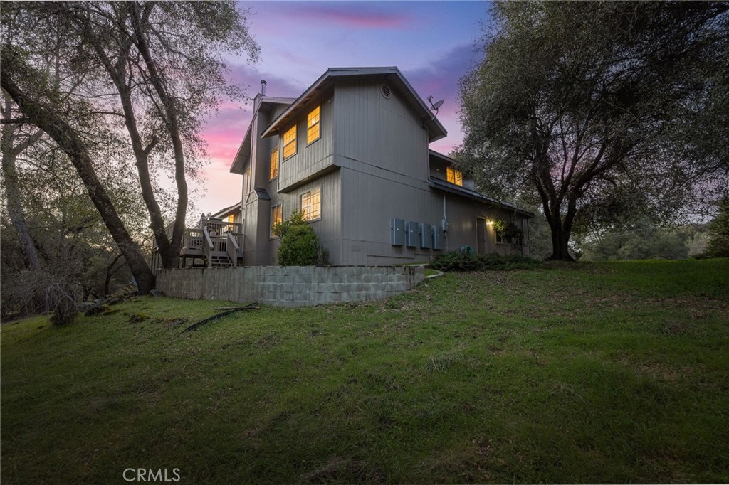 39301 Moonray Lane Oakhurst, CA 93644 - Photo 6 of 55 a front view of a house with a yard
