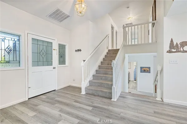 a view of entryway and hall with wooden floor