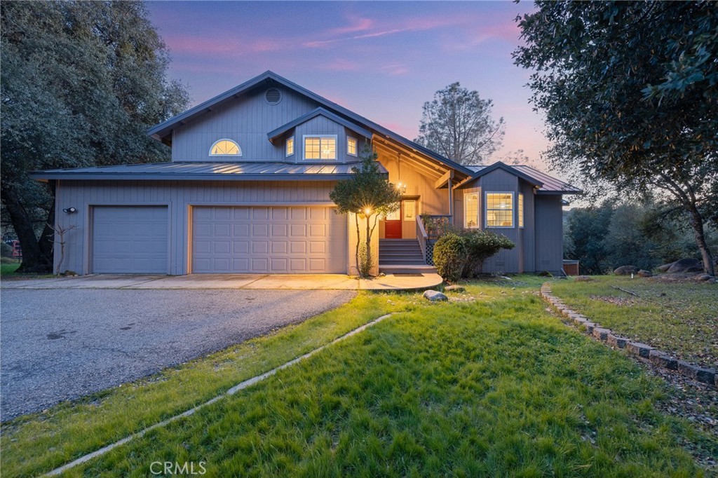39301 Moonray Lane Oakhurst, CA 93644 - Photo 7 of 55 a front view of a house with a yard and garage