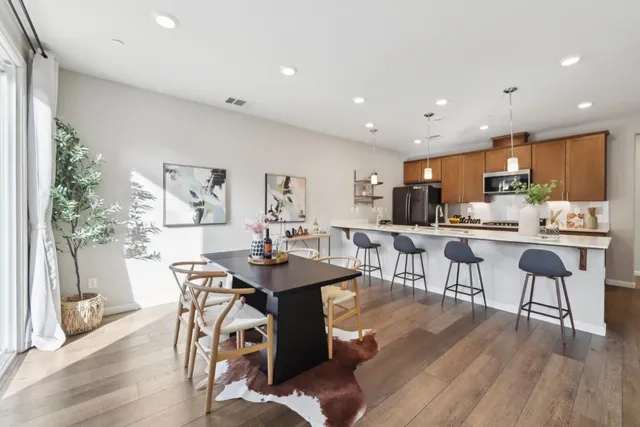 a view of a dining room with furniture and wooden floor