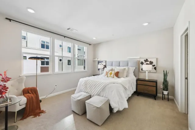 a bedroom with a bed and a couch