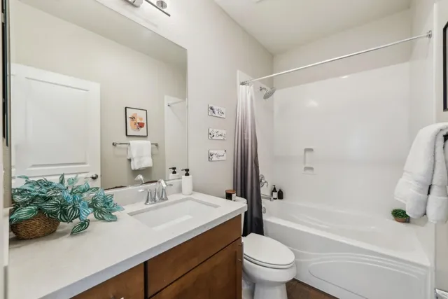 a bathroom with a sink a toilet and a large mirror