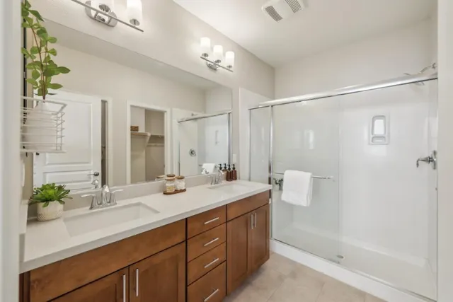 a bathroom with a double vanity sink and mirror