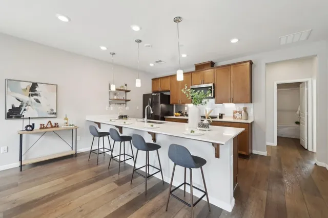a kitchen with stainless steel appliances kitchen island granite countertop a sink and cabinets