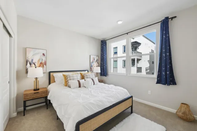 a bedroom with a bed and a painting on the wall