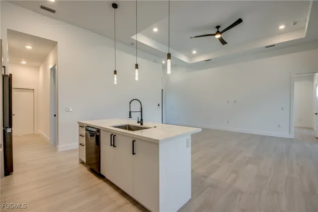 a view of a kitchen with a sink stainless steel appliances and cabinets