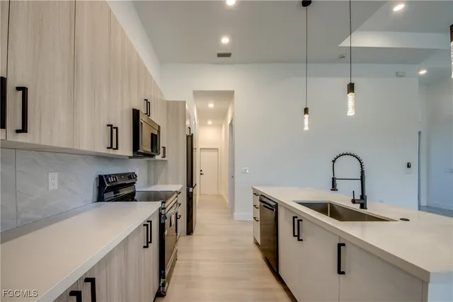 a kitchen with a sink a stove and refrigerator