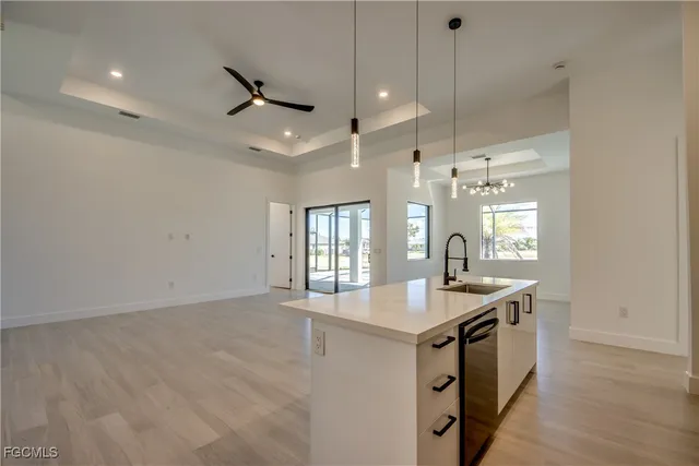 a kitchen with a sink appliances and a large window