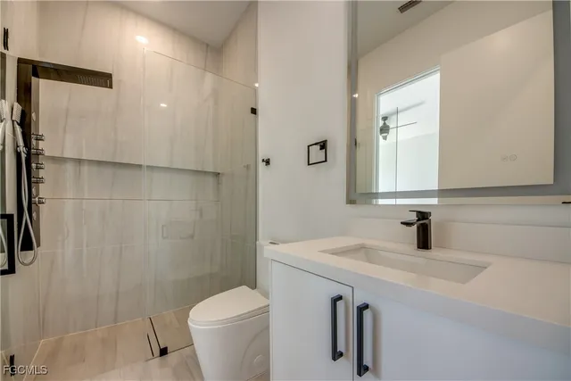 a bathroom with a sink toilet and shower