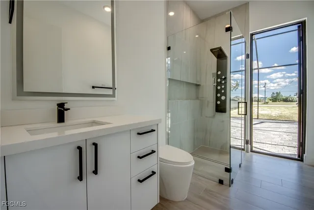a bathroom with a toilet sink and shower