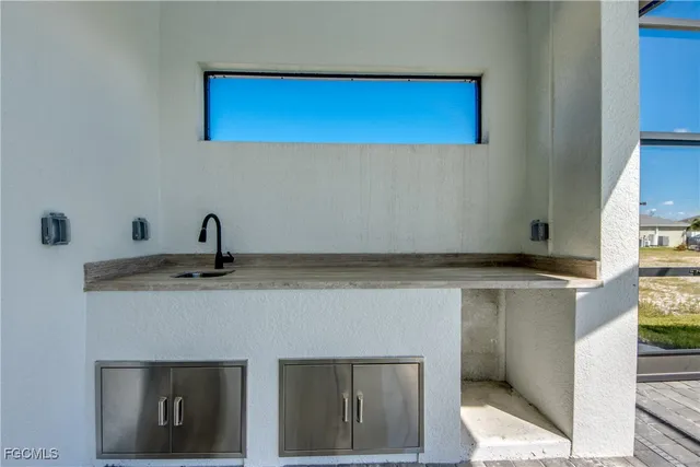 a view of a kitchen with a sink and a refrigerator
