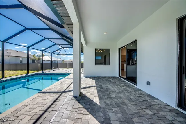 a view of empty room with wooden floor and floor to ceiling window