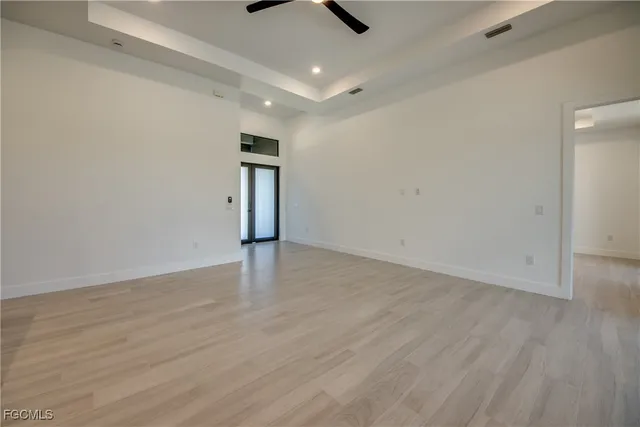 a view of an empty room with wooden floor
