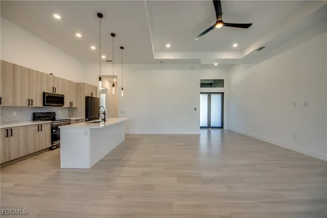 a view of kitchen with microwave and cabinets